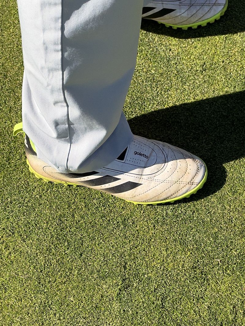 White Goletto turf shoes with black stripes and neon-yellow soles